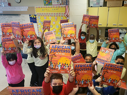 Rosa Parks Elementary students hold up their new books