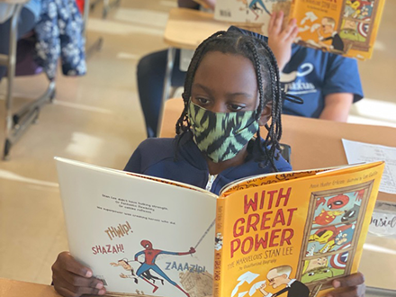 LaSalle Backus Elementary School student reading With Great Power by Annie Hunter Eriksen