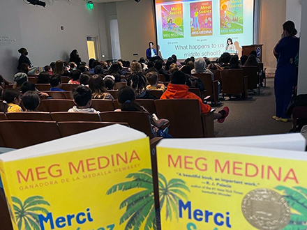 Author Meg Medina with students at Planet World