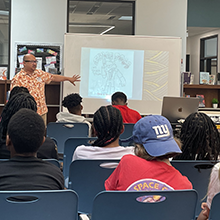 Image of students listening to visiting author.