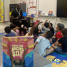 Image of author discussing book with students.