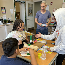 Image of students participating in activity with visiting author.