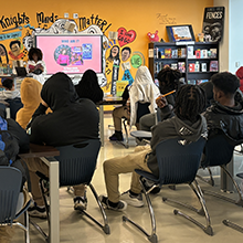 Image of students listening to visiting author.